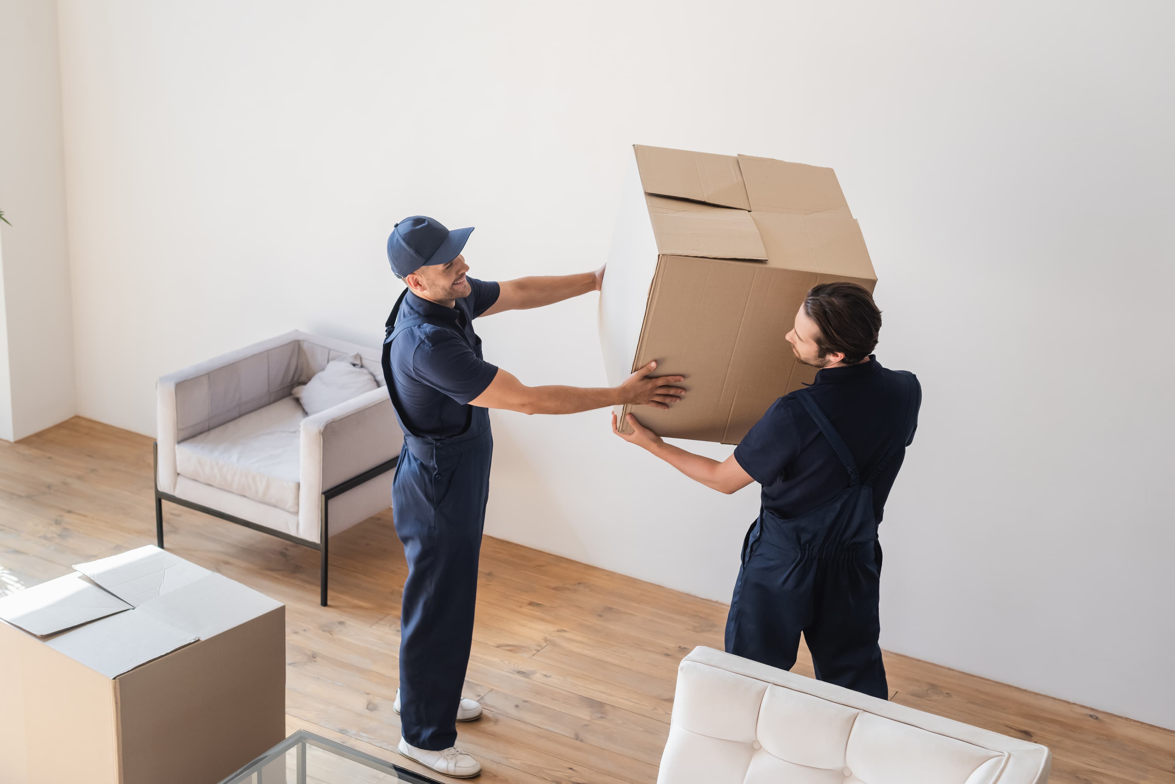 Moving labor crew handling furniture in a St. Pete FL home