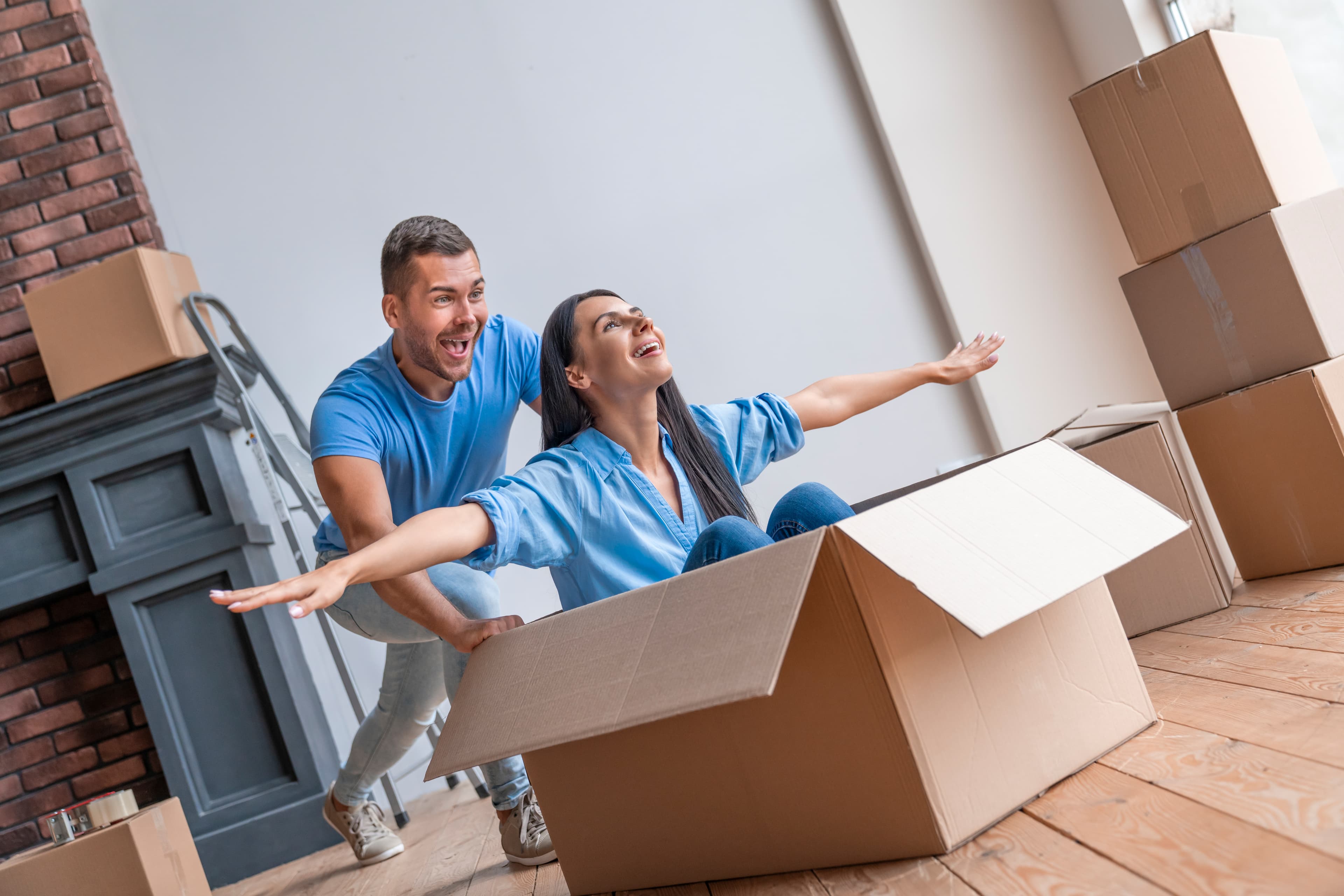 Happy couple with moving boxes and packing supplies in St. Petersburg FL